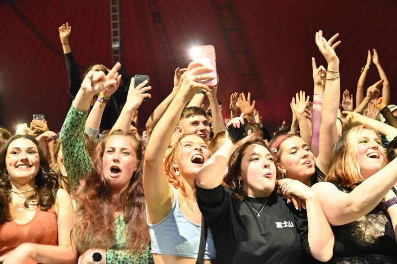 Fans watch Blossom perform at a live music concert hosted by Festival Republic in Sefton Park in Liverpool, north-west England on May 2, 2021, where a non-socially-distanced crowd of 5,000 are expected to attend. - A pilot programme to examine ways of putting on events in a post-covid-19 world will include a concert by the band Blossoms which will do away with social distancing, though audience members will have to provide proof of a negative coronavirus test before gaining entry. (Photo by Paul ELLIS / AFP)