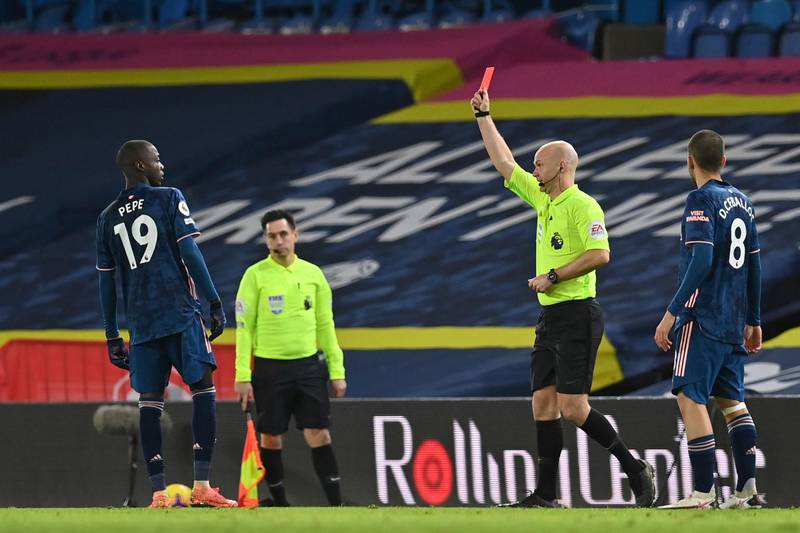 Arsenal's Nicolas Pepe, left, is shown the red card by the referee during an English Premier League soccer match between Leeds United and Arsenal at Elland Road Stadium in Leeds, England, Sunday Nov. 22, 2020. (Paul Ellis/Pool Via AP)
