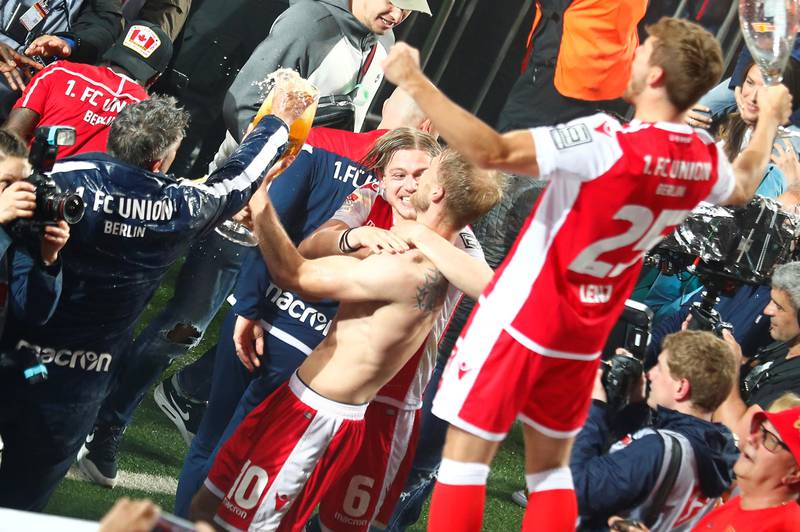 Soccer Football - Bundesliga Relegation Playoff - Union Berlin v VfB Stuttgart - Stadion An der Alten Forsterei, Berlin, Germany - May 27, 2019   Union Berlin coach Urs Fischer, players Sebastian Andersson, Julian Reyerson and Christopher Lenz celebrate after winning the match    REUTERS/Hannibal Hanschke    DFL regulations prohibit any use of photographs as image sequences and/or quasi-video