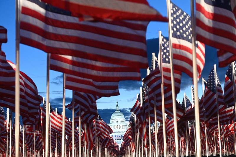 US flags are seen in the early morning as preparations continue for the inauguration of US President-elect Joe Biden on January 20, 2021, at the US Capitol in Washington, DC. (Photo by ROBERTO SCHMIDT / AFP)