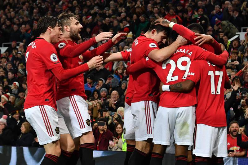 Manchester United's English striker Marcus Rashford celebrates with teammates after scoring their third goal during the English Premier League football match between Manchester United and Newcastle United at Old Trafford in Manchester, north west England, on December 26, 2019. (Photo by Paul ELLIS / AFP) / RESTRICTED TO EDITORIAL USE. No use with unauthorized audio, video, data, fixture lists, club/league logos or 'live' services. Online in-match use limited to 120 images. An additional 40 images may be used in extra time. No video emulation. Social media in-match use limited to 120 images. An additional 40 images may be used in extra time. No use in betting publications, games or single club/league/player publications. / 