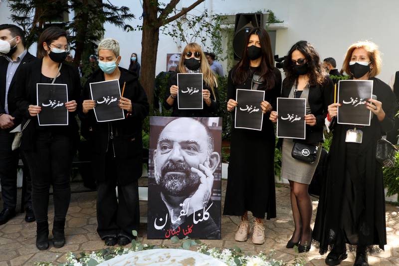 Activists hold up pieces of paper with the words in Arabic, "zero fear" during the memorial service to pay tribute to Lokman Slim, a Shi'ite publisher and activist, who was found dead in his car, in Beirut, Lebanon February 11, 2021. REUTERS/Mohamed Azakir