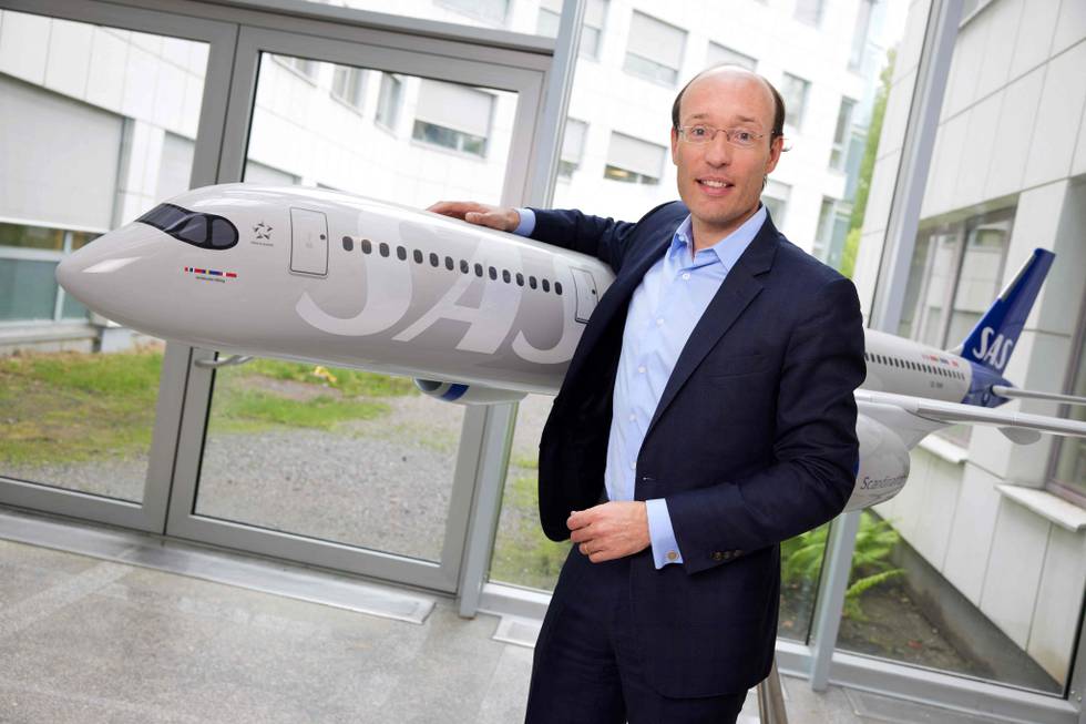 SAS CEO Anko van der Werff poses next to the model of a plane during an interview in connection with the company's interim report released on May 31, 2022 in Stockholm, Sweden. - Ailing Scandinavian airline SAS reported another quarter in the red, albeit a narrower loss, as it said it would press ahead with its cost-cutting plan. (Photo by Fredrik PERSSON / TT NEWS AGENCY / AFP) / Sweden OUT