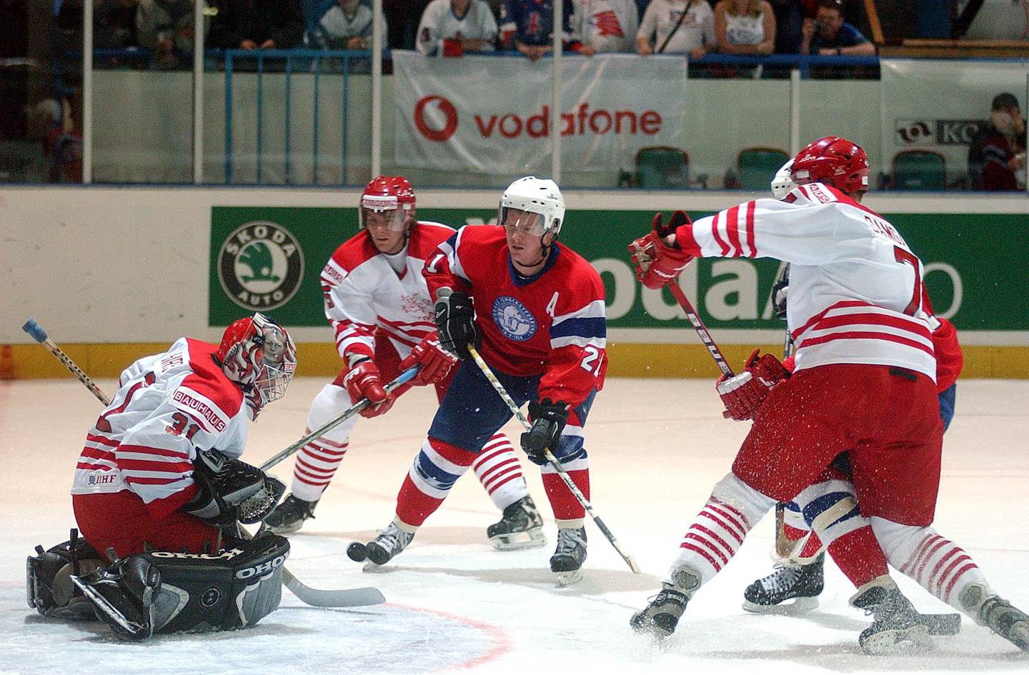 
Trond Magnussen of Norway, in red jersey, center, in action in front of Denmark's goalie Peter Hirch, left, during their match in the fourth round of the Ice Hockey Division I, Group B World Championships in Szekesfehervar, southwest of Budapest, Hungary, on Friday, April 19, 2002. (AP Photo/MTI/Imre Foeldi)