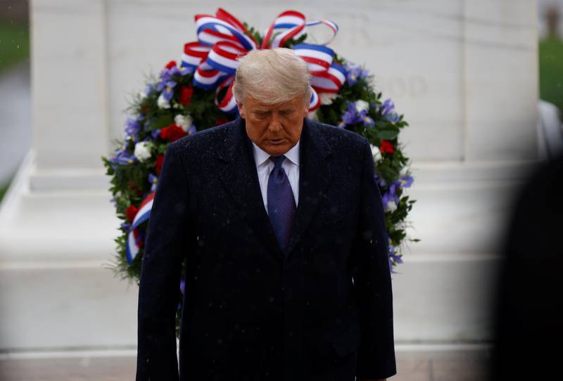 U.S. President Donald Trump turns after laying a wreath at the Tomb of the Unknown Solider as he attends a Veterans Day observance in the rain at Arlington National Cemetery in Arlington, Virginia, U.S., November 11, 2020. REUTERS/Carlos Barria