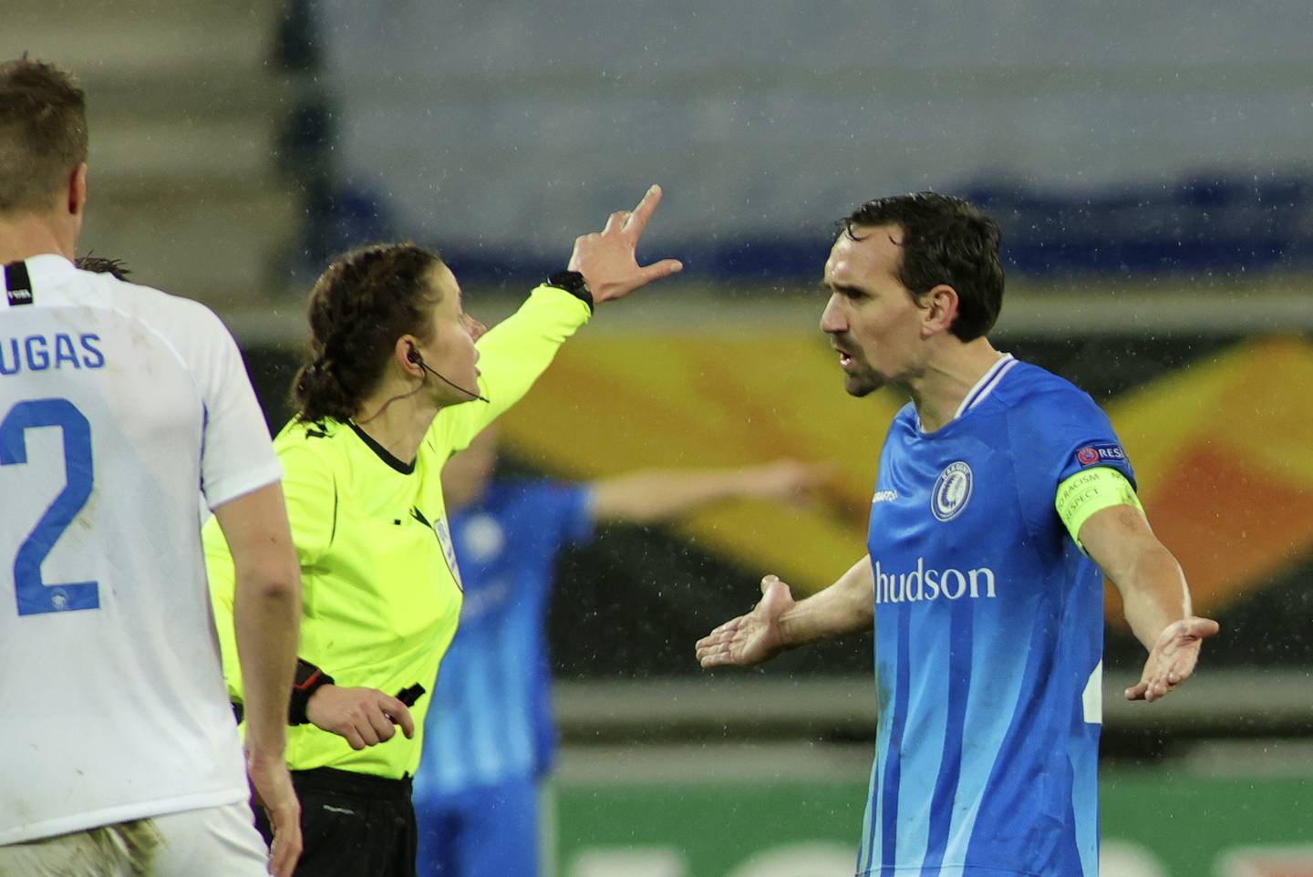 Gent's Sven Kums, right, disputes a call by referee Kateryna Monzul, left, during the Europa League Group L soccer match between Gent and Slovan Liberec at the Ghelamco stadium in Ghent, Belgium, Thursday, Dec. 3, 2020. (AP Photo/Olivier Matthys)
