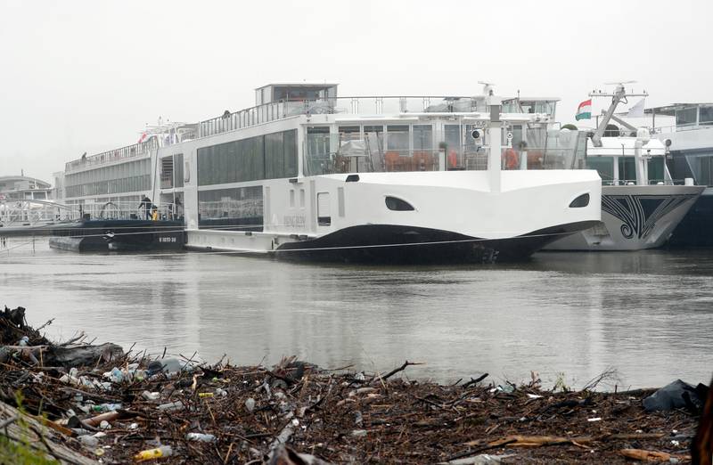 The Viking Sigyn hotel ship is moored following a collision with a sightseeing boat in Budapest, Hungary, Thursday, May 30, 2019. A massive search was underway on the Danube River in downtown Budapest for over a dozen people missing after a sightseeing boat with 33 South Korean tourists sank after colliding with another vessel during an evening downpour. Seven people are confirmed dead, officials said Thursday. (AP Photo/Laszlo Balogh)