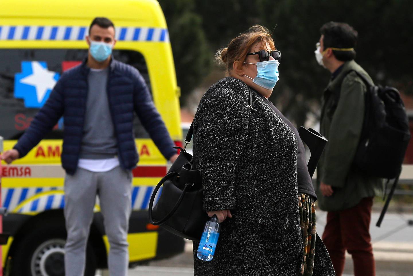 People wear face masks at La Paz hospital in Madrid, Spain, Thursday, March 12, 2020. Exhibitions, conferences, sports centers and museums are closing in Madrid, including the Spanish capital's Prado Museum for the first time in eight decades. For some, especially older adults and people with existing health problems, it can cause more severe illness, including pneumonia. (AP Photo/Manu Fernandez)