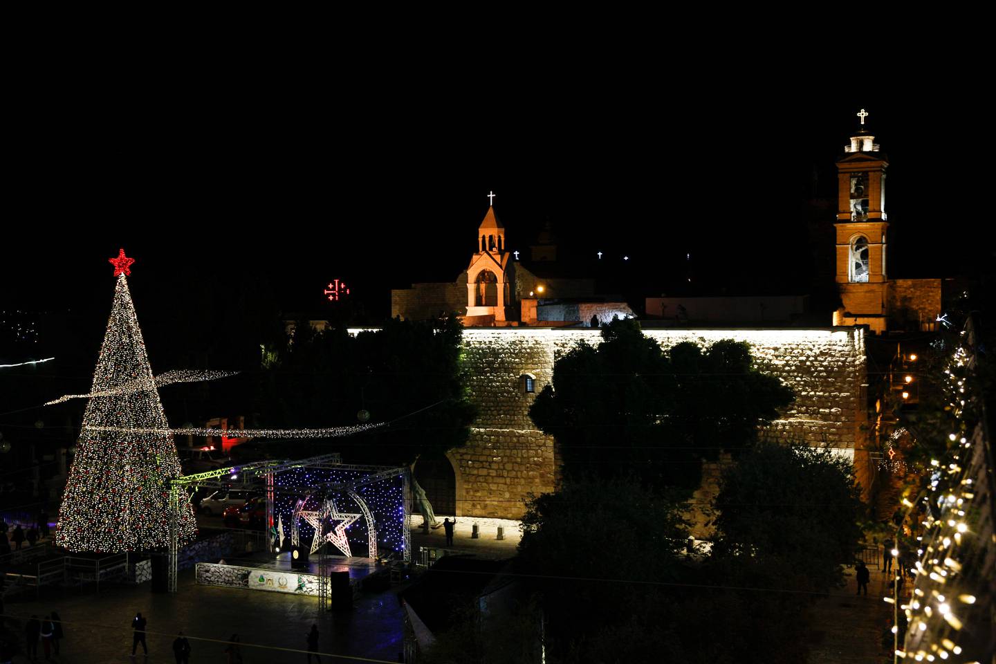 Christmas tree is lit outside the Church of the Nativity, traditionally believed by Christians to be the birthplace of Jesus Christ in the West Bank city of Bethlehem, Saturday, Dec. 5, 2020. (AP Photo/Majdi Mohammed)