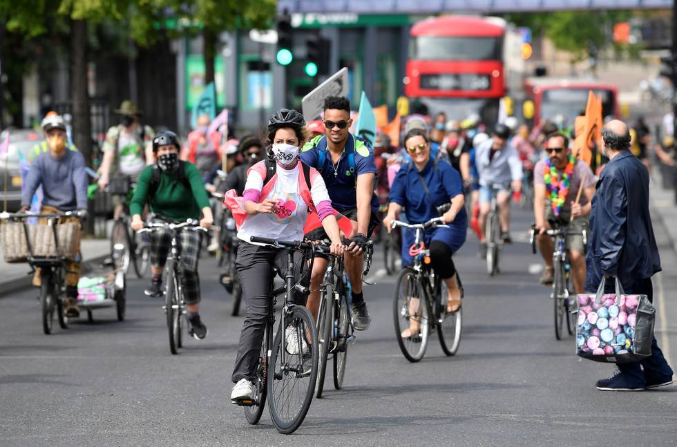 Members of Extinction Rebellion take part in a socially distanced bicycle ride to campaign for more cycling and cycle lanes and fewer vehicles on the roads, following the outbreak of the coronavirus disease (COVID-19), London, Britain, May 17, 2020. REUTERS/Toby Melville