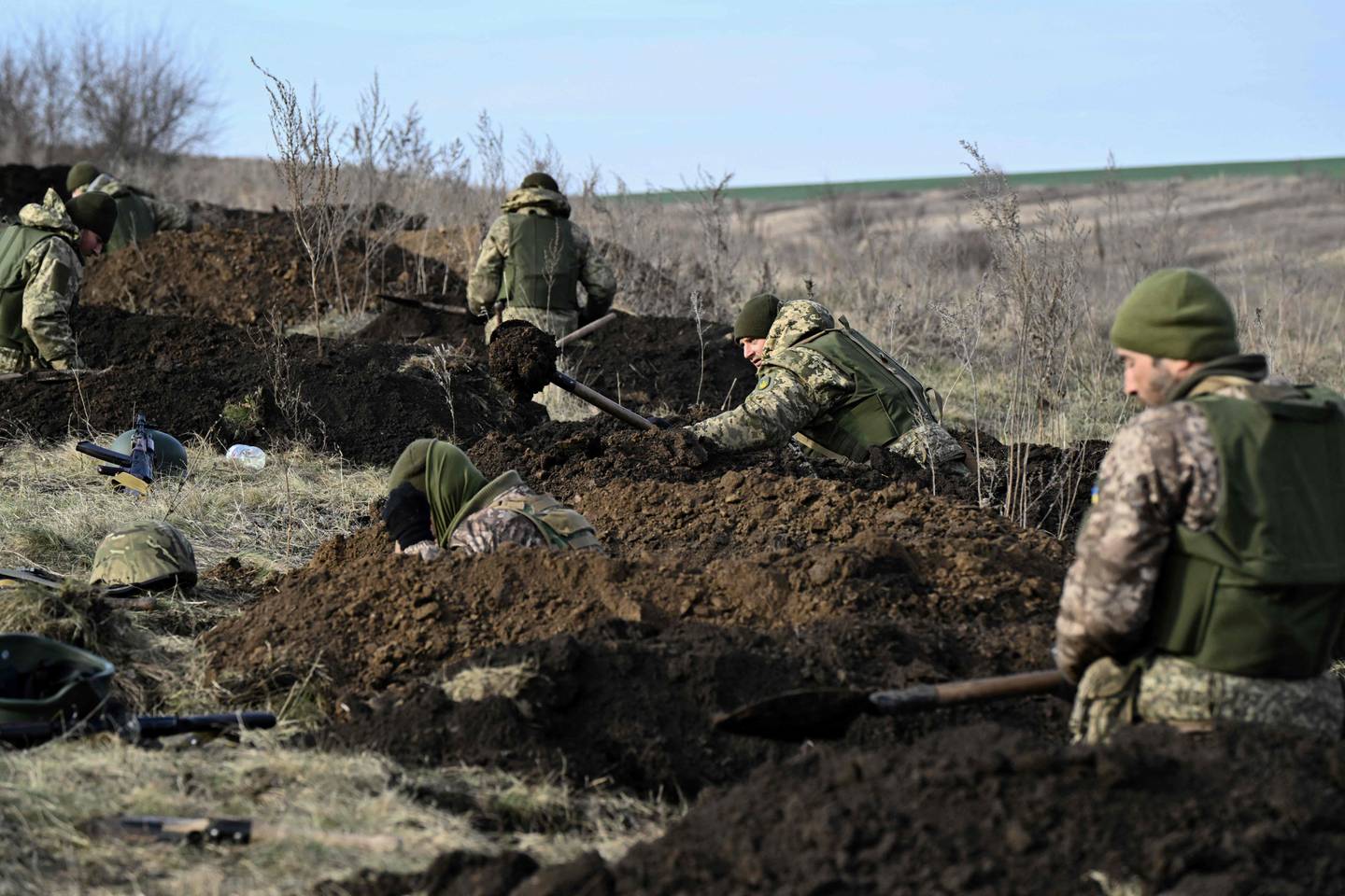 Ukrainian servicemen of the 42nd Mechanised Brigade dig trenches during a field military exercise in the Donetsk region on December 6, 2023, amid the Russian invasion of Ukraine. (Photo by Genya SAVILOV / AFP)