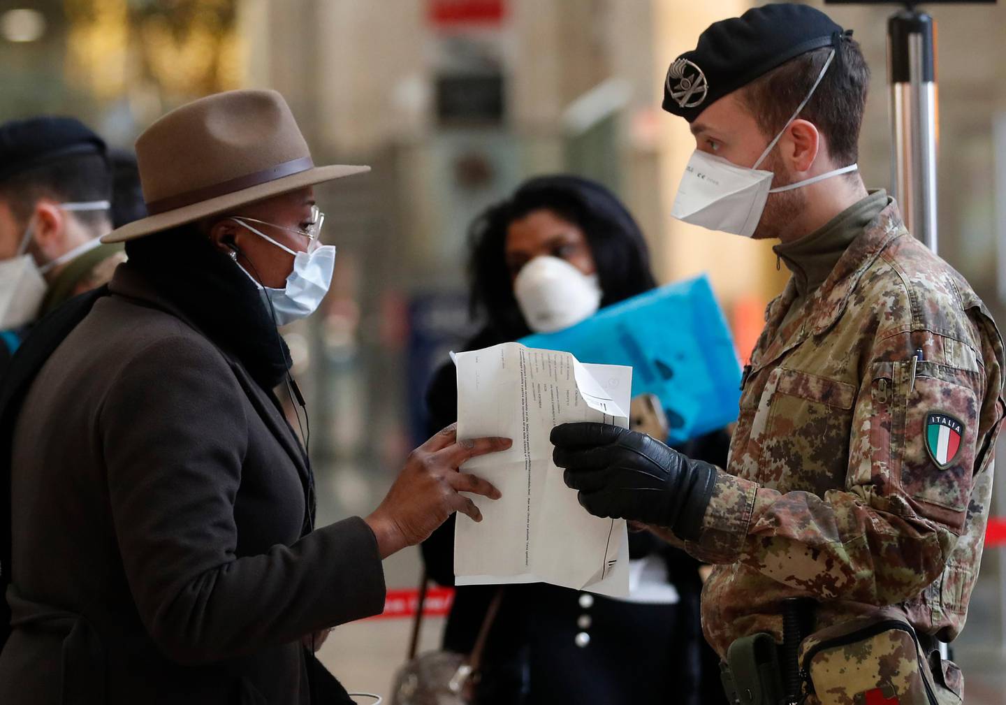 Police officers and soldiers check passengers leaving from Milan main train station, Italy, Monday, March 9, 2020. Italy took a page from China's playbook Sunday, attempting to lock down 16 million people  more than a quarter of its population  for nearly a month to halt the relentless march of the new coronavirus across Europe. Italian Premier Giuseppe Conte signed a quarantine decree early Sunday for the country's prosperous north. Areas under lockdown include Milan, Italy's financial hub and the main city in Lombardy, and Venice, the main city in the neighboring Veneto region. (AP Photo/Antonio Calanni)