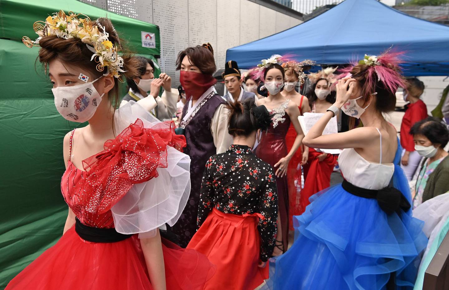 Models wearing face masks prepare backstage prior to a mask fashion show at Gangnam district in Seoul on August 14, 2020 amid the ongoing COVID-19 coronavirus pandemic. (Photo by Jung Yeon-je / AFP)