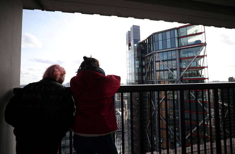 Visitors look out from the Viewing Level towards a luxury block of flats from the Tate Modern gallery in London, Britain, February 12, 2020. REUTERS/Hannah McKay