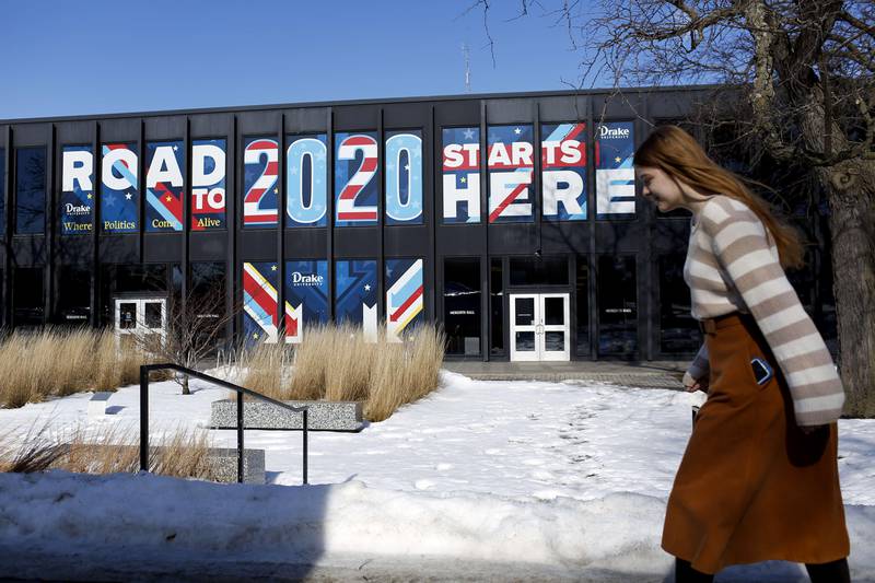 DES MOINES, IA - FEBRUARY 02: A woman walks past a sign displayed on a building a Drake University that reads "Road To 2020 Starts Here" on February 2, 2020 in Des Moines, Iowa. Tomorrow, Iowa voters will go to their local precincts to caucus for a one of several presidential candidates.   Joshua Lott/Getty Images/AFP
== FOR NEWSPAPERS, INTERNET, TELCOS & TELEVISION USE ONLY ==