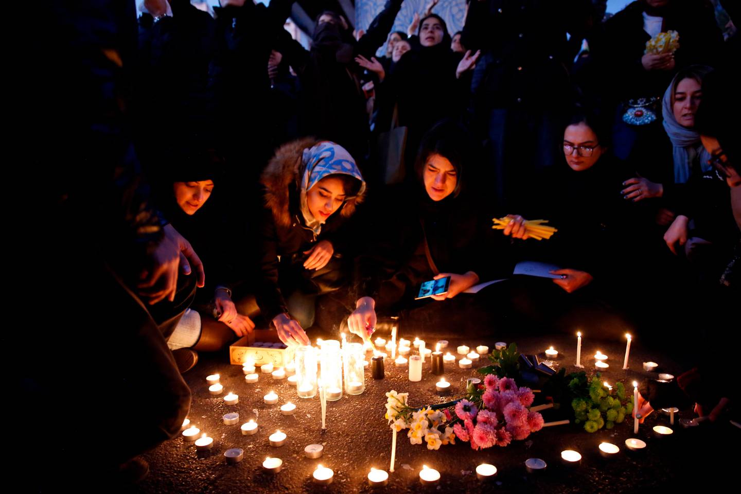 Iranians light candles for the victims of Ukraine International Airlines Boeing 737 during a gathering in front of the Amirkabir University in the capital Tehran, on January 11, 2020. - Iran said it "unintentionally" shot down a Ukrainian passenger jet, killing all 176 people aboard, in an abrupt about-turn after initially denying Western claims it was struck by a missile. President Hassan Rouhani said a military probe into the tragedy had found "missiles fired due to human error" brought down the Boeing 737, calling it an "unforgivable mistake". (Photo by - / AFP)