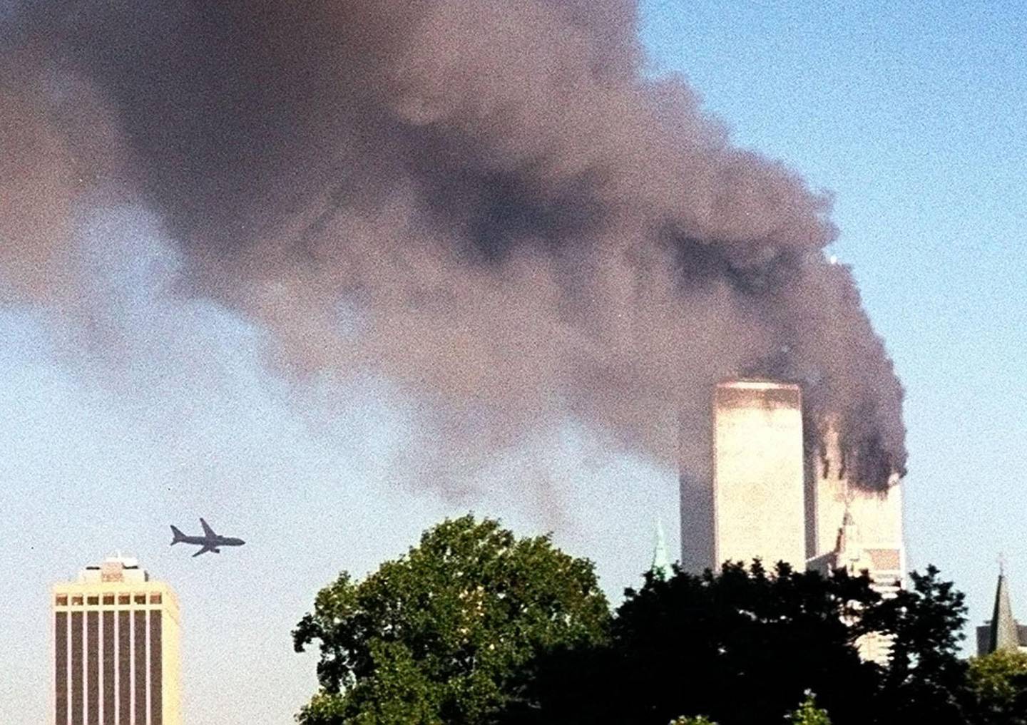 FILE- In this Sept. 11, 2001 file photo, American Airlines Flight 175 closes in on World Trade Center Tower 2 in New York, just before impact.  On Monday, July 15, 2013, a lawsuit commences in New York City that will decide whether the owners of the World Trade Center can try to make several airlines and other aviation defendants pay billions of dollars in damages for their liability in the attacks. (AP Photo/William Kratzke)