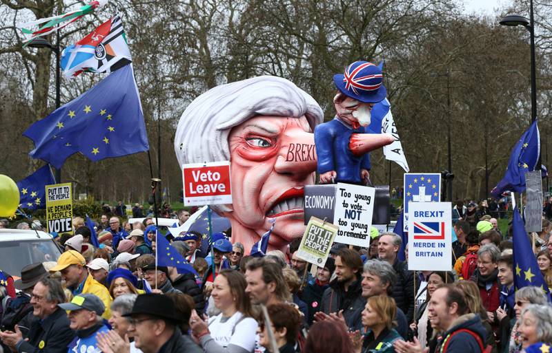 A puppet character depicting British Prime Minister Theresa May is brandished among Anti-Brexit campaigners, during the People's Vote March in London, Saturday March 23, 2019. Protesters are gathering in central London before what is widely predicted to be a massive march in favour of a second Brexit referendum. (Yui Mok/PA via AP)