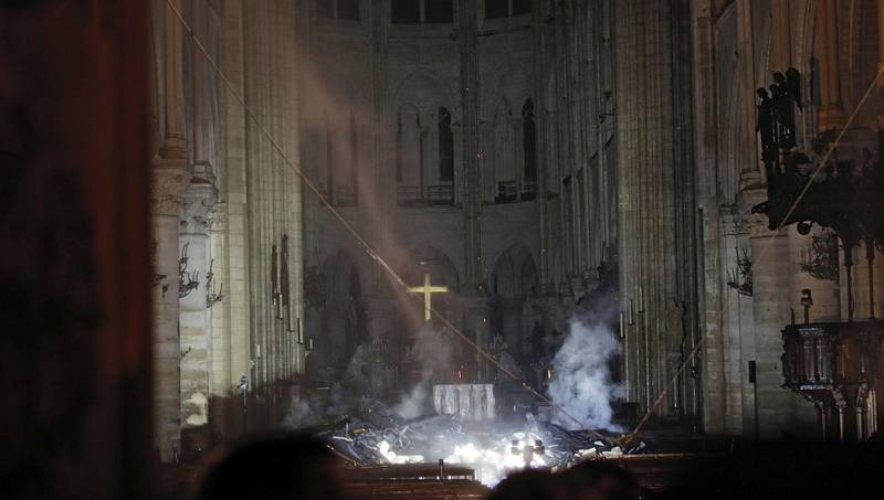 Smoke is seen in the interior of Notre Dame cathedral in Paris, Monday, April 15, 2019. A catastrophic fire engulfed the upper reaches of Paris' soaring Notre Dame Cathedral as it was undergoing renovations Monday, threatening one of the greatest architectural treasures of the Western world as tourists and Parisians looked on aghast from the streets below. (Philippe Wojazer/Pool via AP)