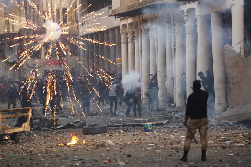 Iraqi demonstrators throw fireworks towards Iraqi security forces during the ongoing anti-government protests in Baghdad, Iraq November 23, 2019. REUTERS/Thaier al-Sudani