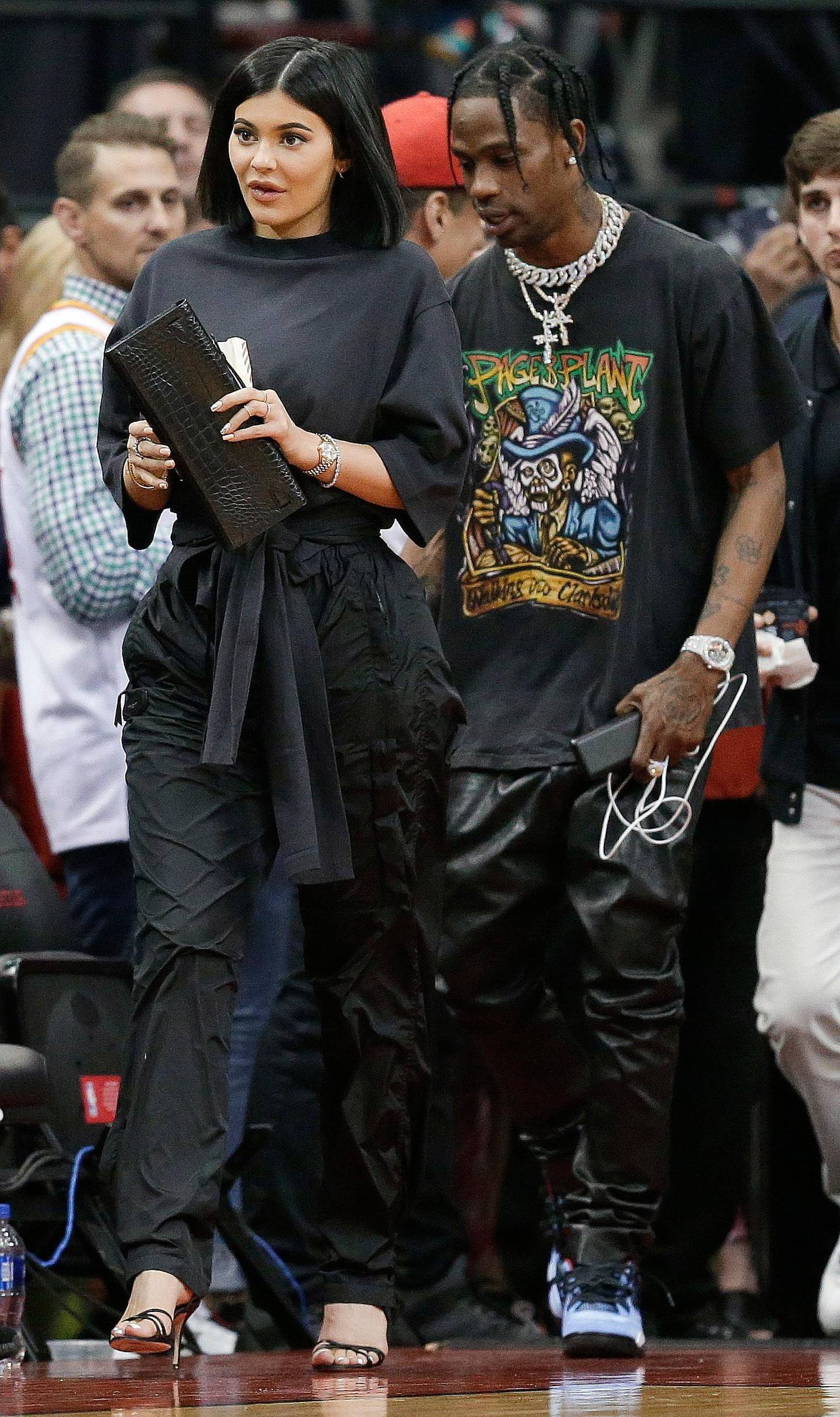 Kylie Jenner, left, and Travis Scott walks to their seats during the second half in Game 2 of a first-round NBA basketball playoff series between the Houston Rockets and the Minnesota Timberwolves, Wednesday, April 18, 2018, in Houston. (AP Photo/Eric Christian Smith)