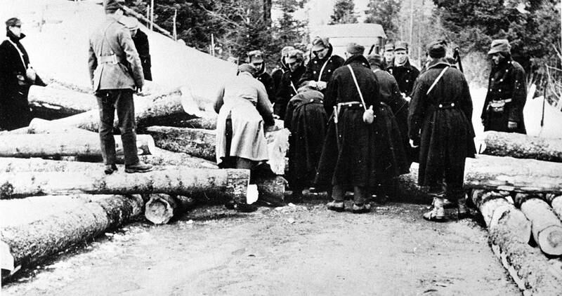 En norsk veisperring bygges ved Gjøvik aprildagene 1940. Tømmerstokker blir brukt til sperringen. FOTO: NTB SCANPIX