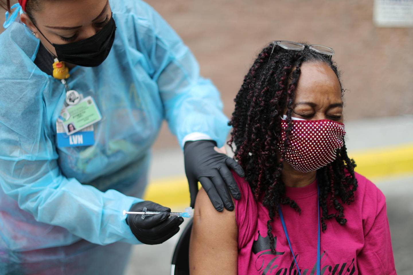 LA Mission guest services tech Felecia Weathersby, 65, receives a coronavirus disease (COVID-19) vaccination at the LA Mission homeless shelter on Skid Row, in Los Angeles, California, U.S., February 10, 2021. REUTERS/Lucy Nicholson