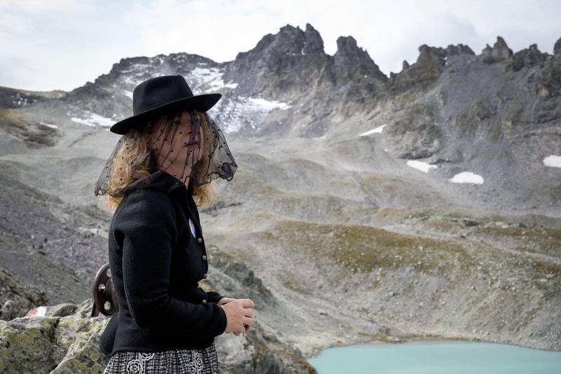 A woman takes part in a ceremony to mark the 'death' of the Pizol glacier (Pizolgletscher) on September 22, 2019 above Mels, eastern Switzerland. - In a study earlier this year, researchers of ETH technical university in Zurich determined that more than 90 percent of Alpine glaciers will disappear by 2100 if greenhouse gas emissions are left unchecked. (Photo by Fabrice COFFRINI / AFP)