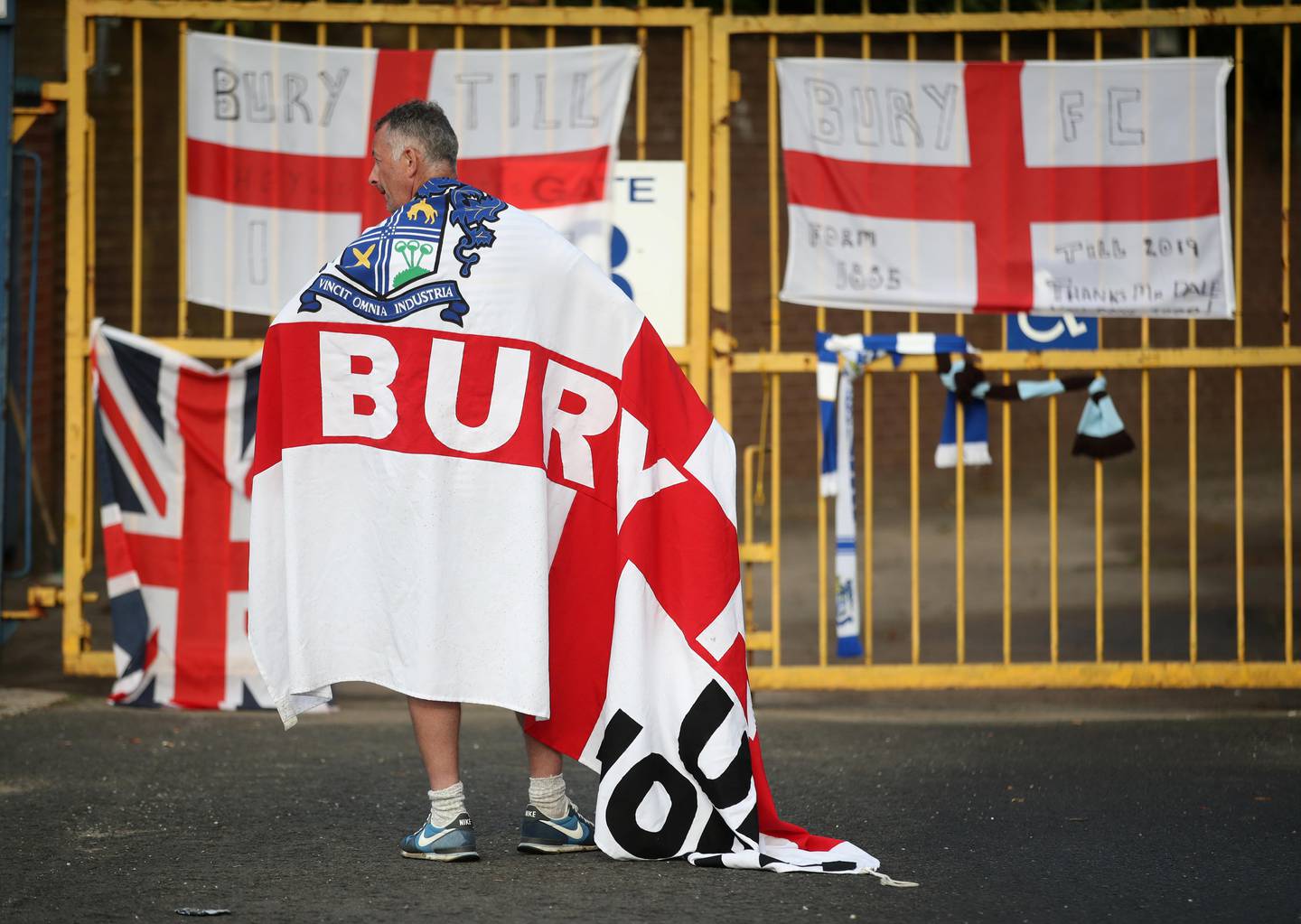 Soccer Football - Bury FC - Gigg Lane, Bury, Britain - August 27, 2019   A Bury FC fan wears a flag outside the stadium   Action Images via Reuters/Carl Recine       TPX IMAGES OF THE DAY