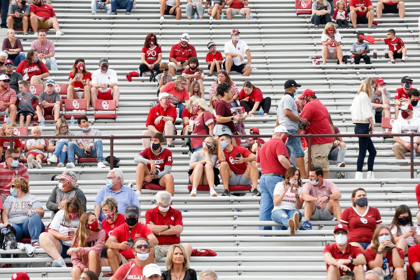 Oklahoma fans find their seats before an NCAA college football game against Missouri State in Norman, Okla., Saturday, Sept. 12, 2020. (Ian Maule/Tulsa World via AP)