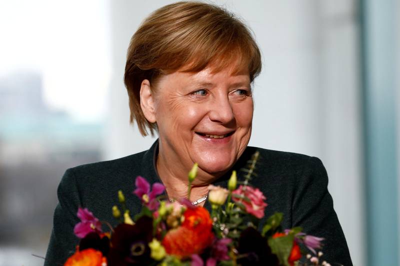 FILE PHOTO: Chancellor Angela Merkel receives Valentine's Day flowers from the  Central Gardening Association in Berlin. Germany, February 11, 2020,    REUTERS/Michele Tantussi/File Photo