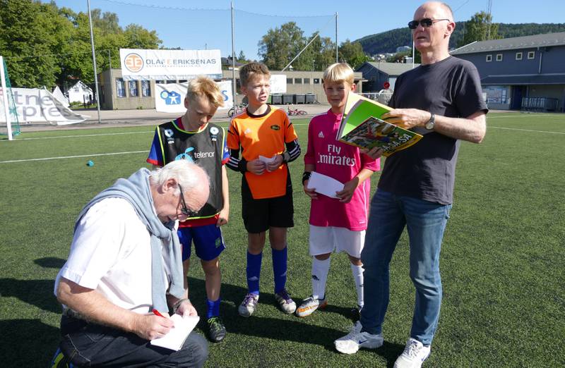 Frank Olafsen skriver autografer til Oskar Melvold, Eirik Hoel og Ola Dybwad, mens forfatter Eirik Lindahl bivåner.  FOTO: REIDAR SOLLIE