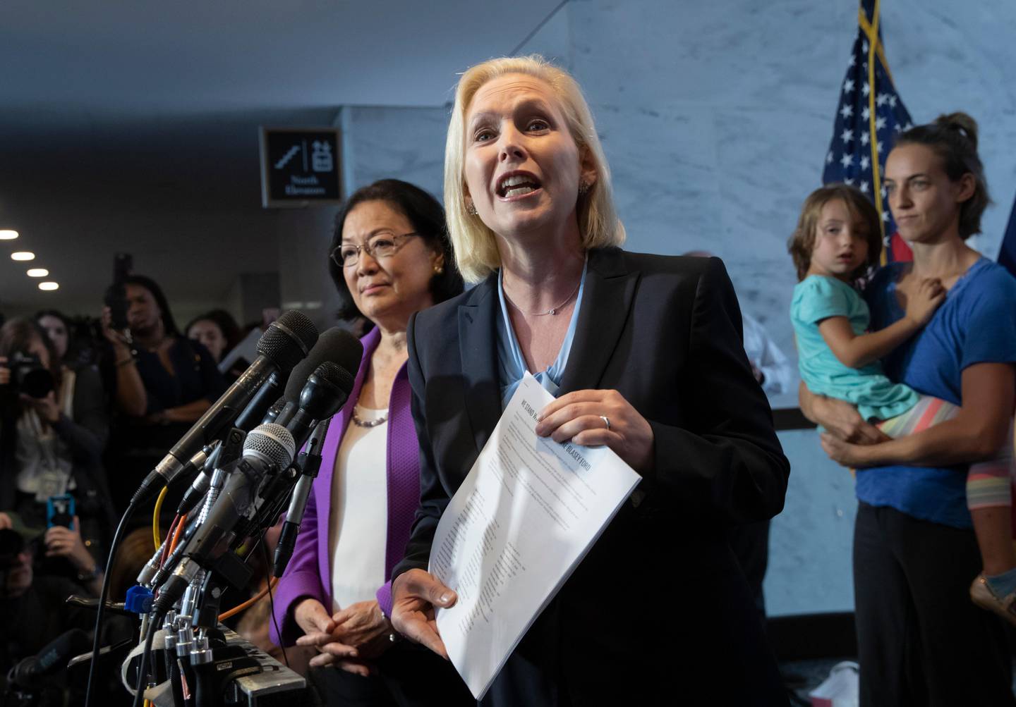 Sen. Kirsten Gillibrand, D-N.Y., with Sen. Mazie Hirono, D-Hawaii, left, joined by former students from Holton Arms School, speaks to reporters in support of professor Christine Blasey Ford, who is accusing Supreme Court nominee Brett Kavanaugh of a decades-old sexual attack, during a news conference on Capitol Hill in Washington, Thursday, Sept. 20, 2018. (AP Photo/J. Scott Applewhite)