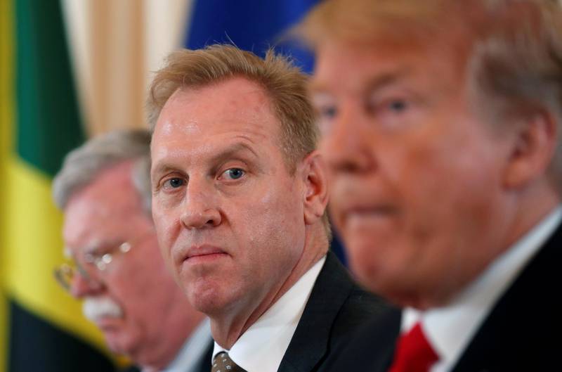 FILE PHOTO: Acting Defense Secretary Patrick Shanahan, seated between National Security adviser John Bolton and U.S. President Donald Trump, listens during a meeting at Mar-a-Lago in Palm Beach, Florida, U.S., March 22, 2019.   REUTERS/Kevin Lamarque/File Photo
