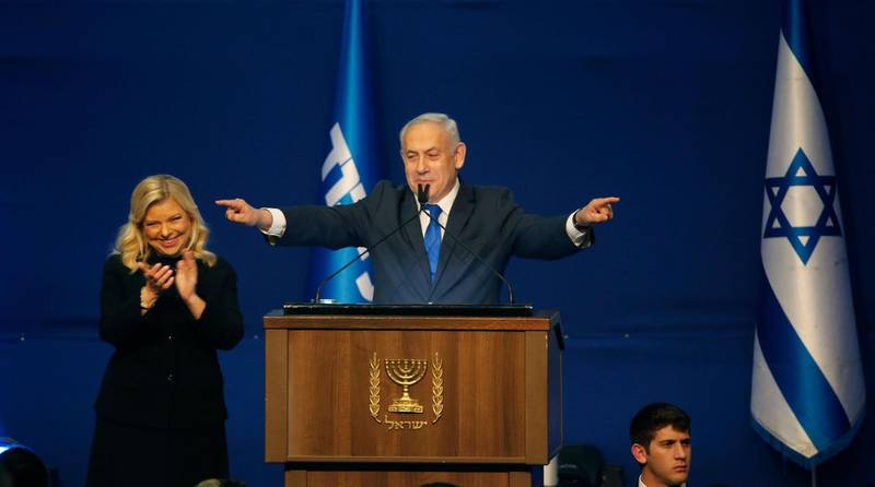 Israeli Prime Minister Benjamin Netanyahu and his wife Sara address supporters at the Likud party campaign headquarters in the coastal city of Tel Aviv early on March 3, 2020, after polls officially closed. - Netanyahu claimed "a giant victory" in elections on March 3, boasting that his right-wing Likud party had defied "all expectations" in the country's third vote in less than a year. After exit polls by three networks forecast that Likud and its allies were on track to win 59 parliamentary seats -- two short of majority -- the premier mocked those who "predicted the end of Netanyahu". (Photo by GIL COHEN-MAGEN / AFP)