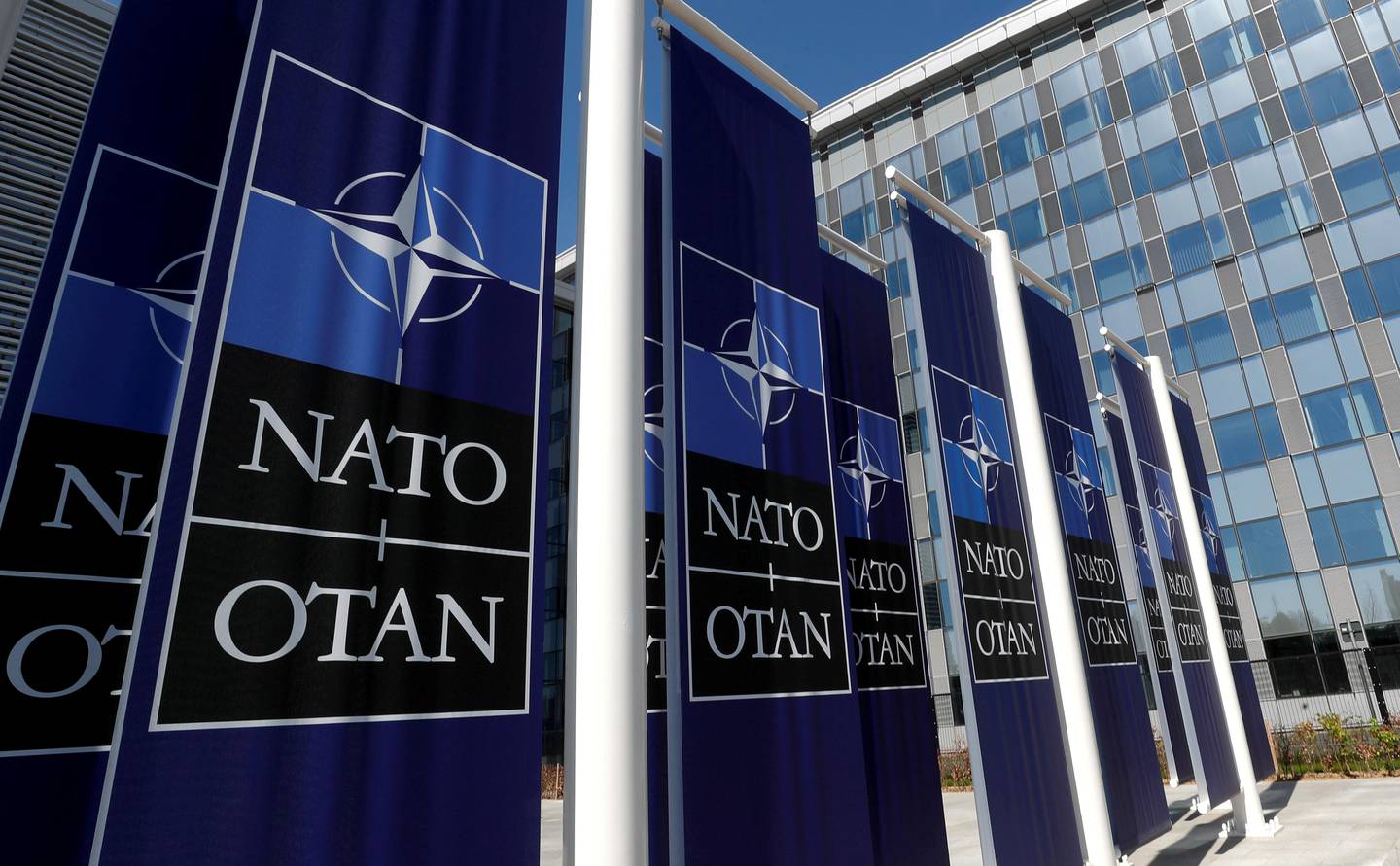 FILE PHOTO: Banners displaying the NATO logo are placed at the entrance of new NATO headquarters during the move to the new building, in Brussels, Belgium April 19, 2018.  REUTERS/Yves Herman/File Photo/File Photo