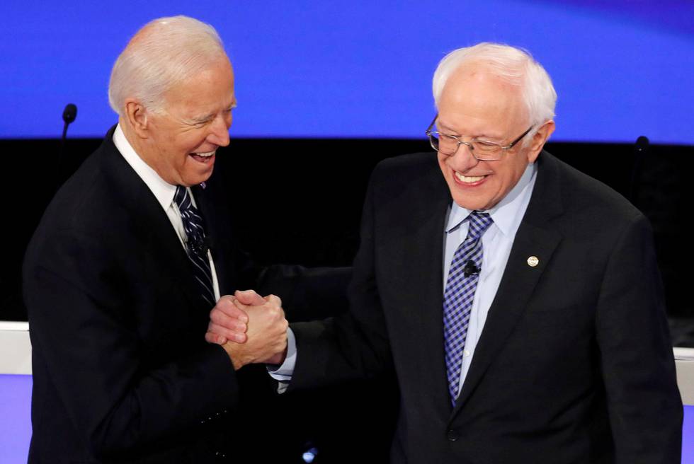 Democratic 2020 U.S. presidential candidates (L-R) former Vice President Joe Biden greeets Senator Bernie Sanders (I-VT) as they take the stage for the seventh Democratic 2020 presidential debate at Drake University in Des Moines, Iowa, U.S., January 14, 2020. REUTERS/Shannon Stapleton     TPX IMAGES OF THE DAY