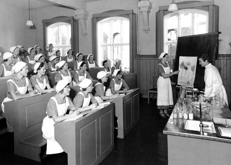 Ikke bare praktisk husstell, men også teori om ernæring, helse og elektrisitet sto på Oslo kommunale husmorskoles pensum, her undervisning i auditorium i 1937.