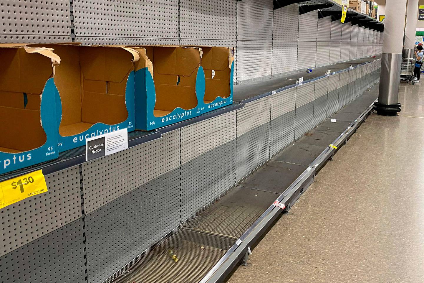Shelves usually stocked with toilet rolls are seen empty in a supermarket following panic buying in Sydney on March 8, 2020. - A fight over toilet paper in an Australian supermarket on March 7 prompted police to call for calm after the latest violence sparked by coronavirus-induced panic buying in the country. (Photo by Saeed KHAN / AFP)