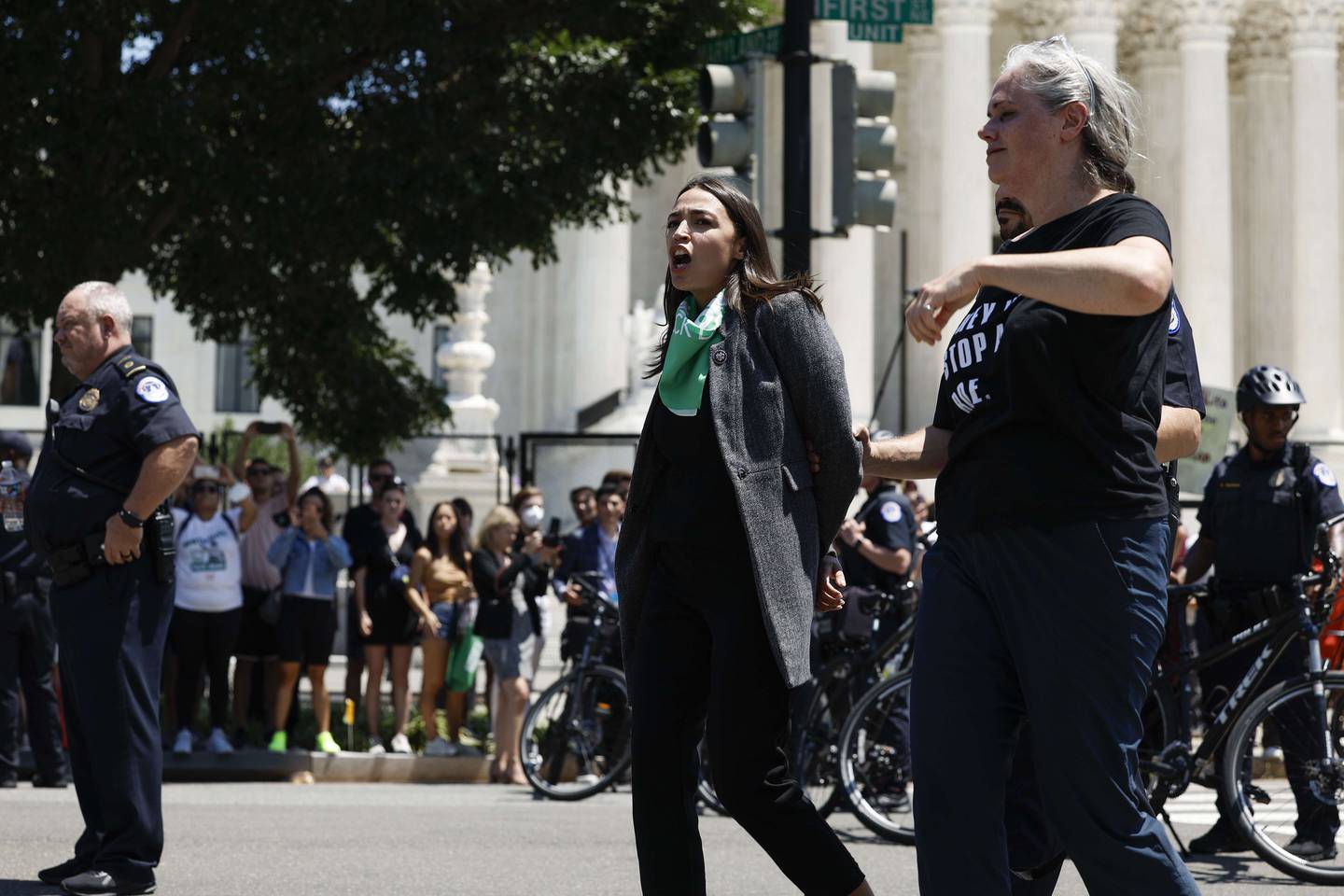 WASHINGTON, DC - JULY 19: Rep. Alexandria Ocasio-Cortez (D-NY) is detained by U.S. Capitol Police Officers after participating in a sit in with activists from Center for Popular Democracy Action (CPDA) in front of the U.S. Supreme Court Building on July 19, 2022 in Washington, DC. The CPDA held the protest with House Democrats in support of abortion rights.   Anna Moneymaker/Getty Images/AFP