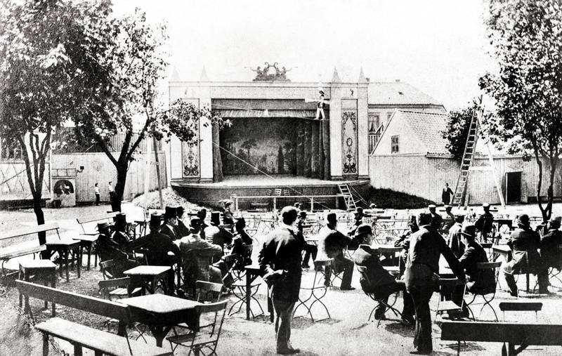 Friluftsscenen i Tivoli i 1878 med linedanser og publikum. I bakgrunnen skimtes Tivoli Theater.