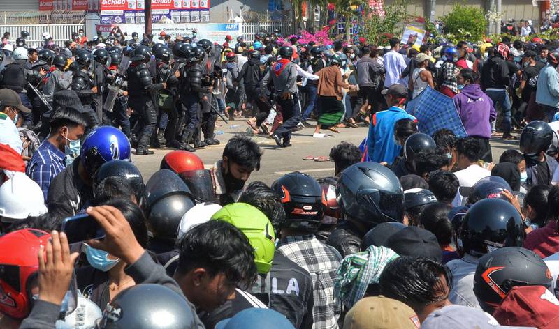 Riot police confront protesters as they continue to demonstrate against the February 1 military coup in the capital Naypyidaw on February 9, 2021. (Photo by STR / AFP)