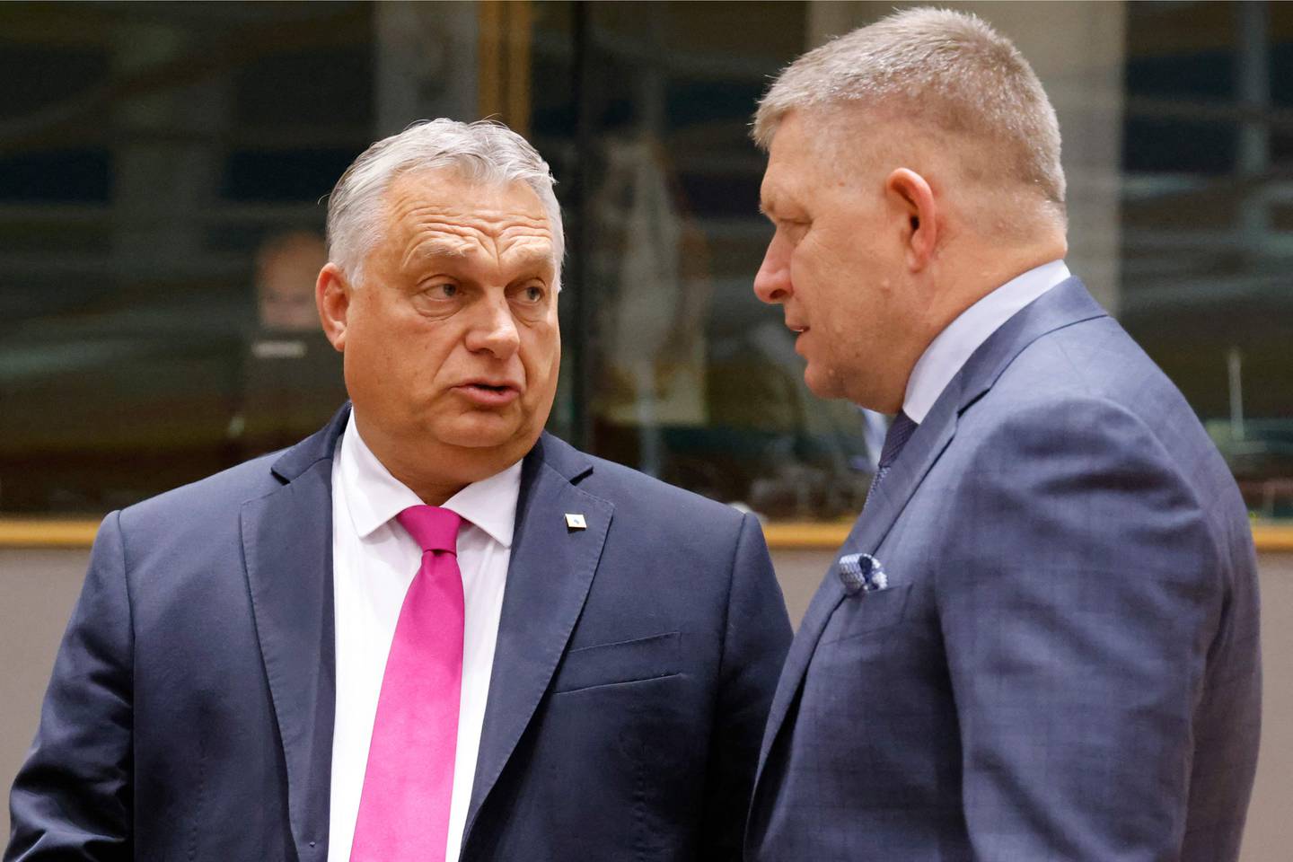 Hungary's Prime Minister Viktor Orban (L) speaks with Slovakia's Prime Minister Robert Fico prior to the start of a EU leaders Summit at The European Council Building in Brussels on October 26, 2023. EU leaders will debate starting October 26, 2023, in a two day summit in Brussels, for a call for humanitarian "pauses" in Israel's war with Hamas, as the bloc grapples with another conflict on its fringes alongside Russia's invasion of Ukraine. (Photo by Ludovic MARIN / AFP)