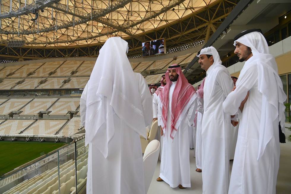 This handout picture released by the Qatar Amiri Diwan on December 9, 2021, shows Qatar's Emir Sheikh Tamim bin Hamad al-Thani (2nd-R) touring Saudi Crown Prince Mohammed bin Salman (C) as they visit Lusail Stadium, one of the venues hosting matches in the upcoming Qatar 2022 FIFA World Cup, in Lusail, Qatar. (Photo by Qatar Amiri Diwan / AFP) / RESTRICTED TO EDITORIAL USE - MANDATORY CREDIT "AFP PHOTO / QATAR AMIRI DIWAN" - NO MARKETING NO ADVERTISING CAMPAIGNS - DISTRIBUTED AS A SERVICE TO CLIENTS