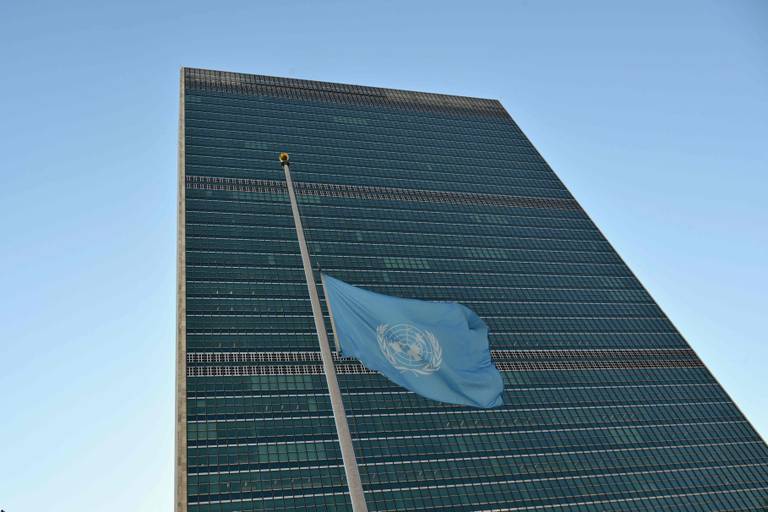A flag is flown at half mast at the United Nations headquarters in New York on November 13, 2023 as staff observe a minute's silence in memory of colleagues killed in Gaza during the Israel-Hamas conflict. The UN agency for supporting Palestinians (UNRWA) announced on November 10 that more than 100 of its employees had died in the Gaza Strip since the start of the war. (Photo by ANGELA WEISS / AFP)
