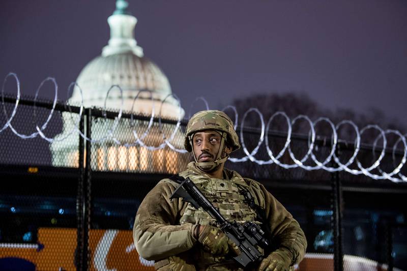 WASHINGTON, DC - JANUARY 15: VA National Guard stands outside the razor wire fencing that surrounds the US Capitol on January 15, 2021 in Washington, DC. After last week's Capitol Riot the FBI has warned of additional threats against the US Capitol and in all 50 states. According to reports, as many as 25,000 National Guard soldiers will be guarding the city as preparations are made for the inauguration of Joe Biden as the 46th U.S. President.   Liz Lynch/Getty Images/AFP
== FOR NEWSPAPERS, INTERNET, TELCOS & TELEVISION USE ONLY ==