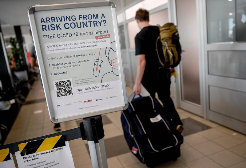 A traveller passes a new corona test station at the 'Schoenefeld' airport in Berlin, Germany, July 31, 2020. The first travellers returning from high-risk areas have been tested for the corona virus. (Photo/ Britta Pedersen/dpa via AP)