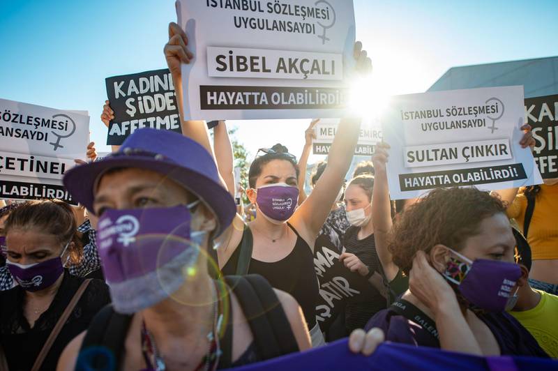 Demonstrators wearing protective face masks hold up placards during a demonstration for a better implementation of the Istanbul Convention and the Turkish Law 6284 for the protection of the family and prevention of violence against women, in Istanbul, Turkey, on August 5, 2020. (Photo by Yasin AKGUL / AFP)