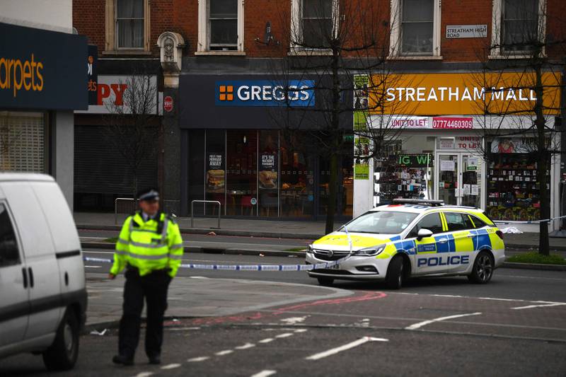 Police attend the scene after an incident in Streatham, London, Sunday Feb. 2, 2020. London police say officers shot a man during a terrorism-related incident that involved the stabbings of a number of people. (Victoria Jones/PA via AP)
