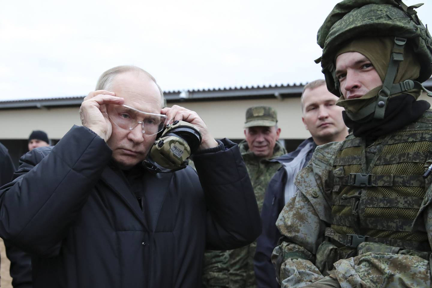 FILE - Russian President Vladimir Putin puts on protective glasses as he visits a military training center of the Western Military District for mobilized reservists in Ryazan Region, Russia, Thursday, Oct. 20, 2022.  (Mikhail Klimentyev, Sputnik, Kremlin Pool Photo via AP, File)